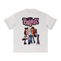 A light oat gray premium cotton TOTZ WORLD  t-shirt featuring a large BRATZ graphic print on the back. The graphic displays the word 'Bratz' in a pink glittery font with a halo above four cartoon-style Bratz sisters wearing jeans and boots.