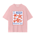 A light pink TOTZ WORLD  cotton short-sleeve t-shirt with a graphic print on the front featuring orange starfish and the text 'I NEED Vitamin Sea' in blue and orange, set against a plain white background.