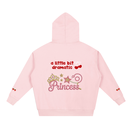 A light pink TOTZ WORLD premium heavyweight warm hoodie shown from the back, featuring a decorative graphic with the text 'a little bit dramatic Princess' and cherries.