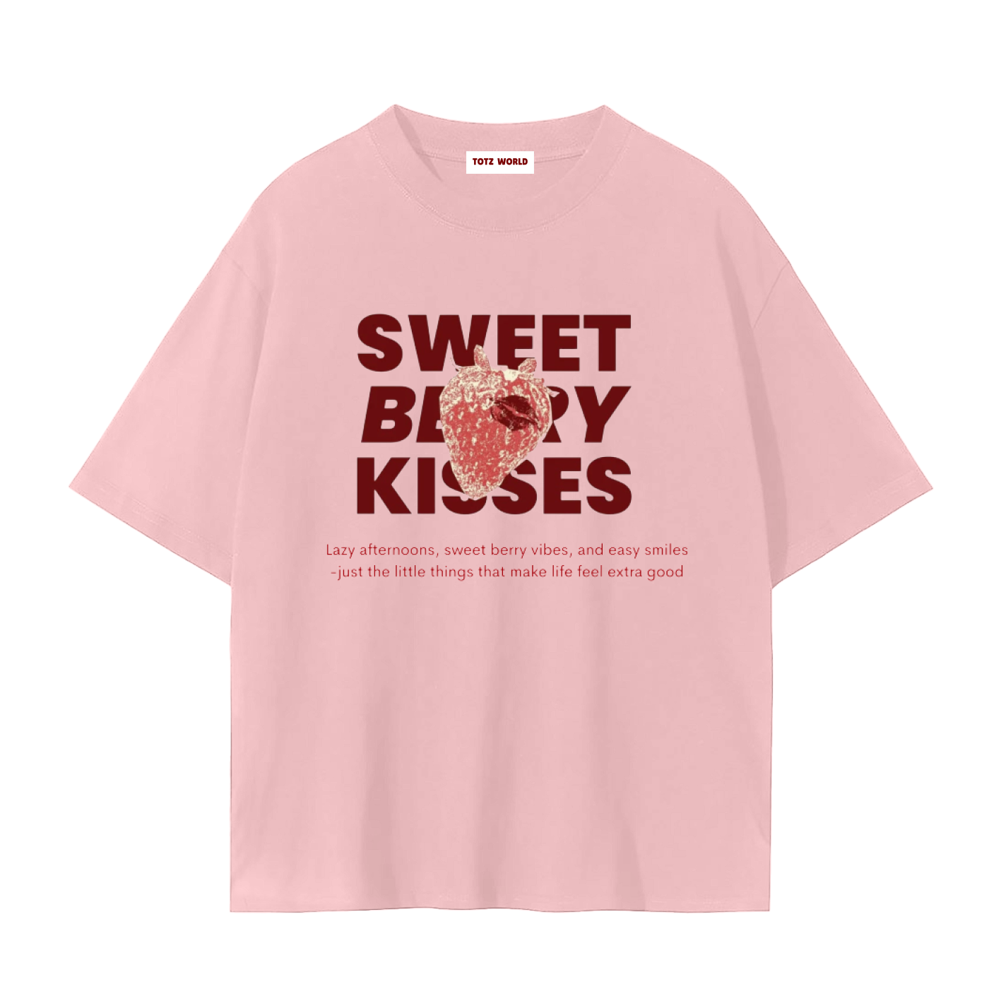 A light pink TOTZ WORLD  premuim cotton short-sleeve t-shirt with a graphic on the front reading 'SWEET BERRY KISSES' in dark red, featuring a strawberry illustration and a small tag at the inner collar that reads 'TOTZ  WORLD'.