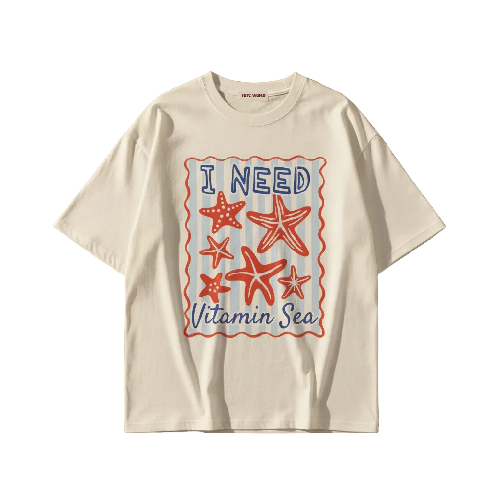 A white  TOTZ WORLD short-sleeve t-shirt with a colorful graphic on the front featuring red and blue starfish and the text 'I NEED Vitamin Sea' inside a wavy red border.